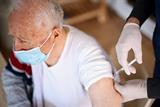 Older man receiving a vaccination