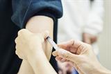 Person receiving a vaccination in their arm