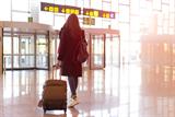 Woman walking through airport