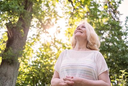 Woman walking in the park in summer day