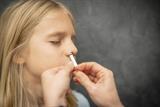 Girl receiving the nasal flu vaccine