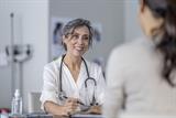 Female GP listening to a patient