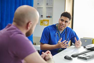 Male GP in consultation with a male patient