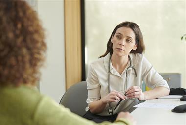 Female GP listening to patient