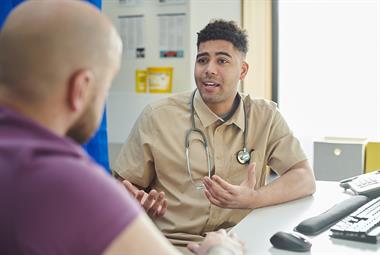 Male GP in consultation with a male patient