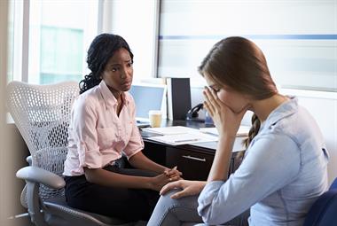 GP in consultation with a young female patient