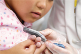 A child having a blood test for diabetes